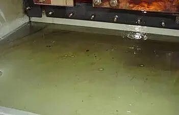 A kitchen sink with water running all over it.